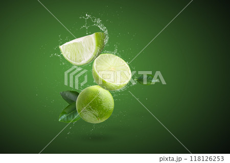 Water splashing on Fresh green lime and leaves isolated on a green background 118126253