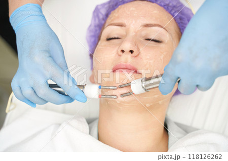 Dermatology anti age treatment. Microcurrent medicine procedure. Woman skin care Dermatology anti age treatment. Microcurrent medicine procedure. Woman skin care 118126262