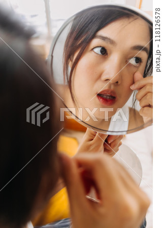 Woman using mirror for wearing make up. Woman using mirror for wearing make up. 118126578