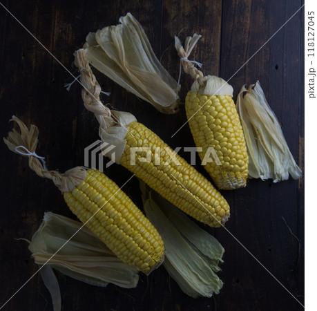 corn cobs in dark wooden background. 118127045