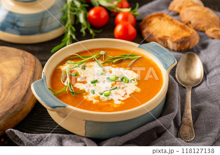 Tomato soup on dark wooden background 118127138