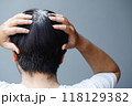 Back view of young people premature gray hair, showing black hoary hair roots on head change to senior old man outdoor. 118129382