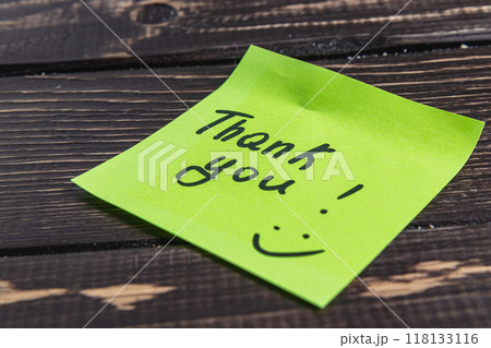 The word thank you for the light on a green leaf on a wooden background The word thank you for the light on a green leaf on a wooden background 118133116