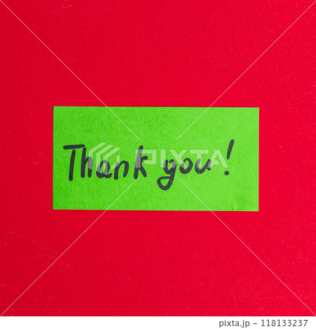 Green small note with the word thank you on a red background Green small note with the word thank you on a red background 118133237