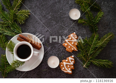 Home 2025 theme white coffee cup with number 2024 over frothy surface flat lay on green background with wooden house model, green plant, coffee beans and star anise. New year's resolutions for family. 118136916