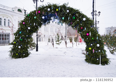 exterior fairytale house with Christmas decor, doors with Christmas tree, red toys, gift boxes and lollipop, decorated entrance to the cafe, winter decor idea exterior fairytale house with Christmas decor, doors with Christmas tree, red toys, gift boxes and lollipop, decorated entrance to the cafe, winter decor idea 118136952
