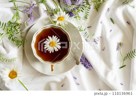 Herbal tea, chamomile flowers and honey on rattan matting Close-up 118136961