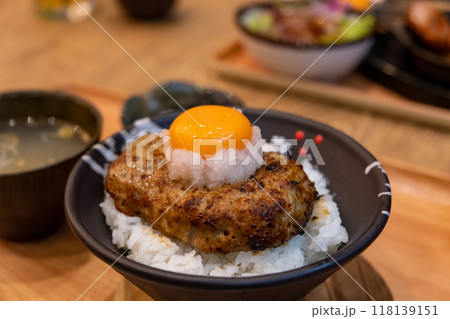 Hamburg steak on rice bowl, with fresh egg on the top. Japanese food Hamburg steak on rice bowl, with fresh egg on the top. Japanese food 118139151