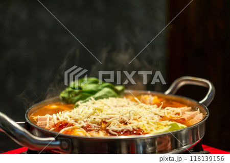 Korean hot pot, Ramyeon and Tteokbokki in Kimchi soup with vegetable, meat and cheese on top 118139156