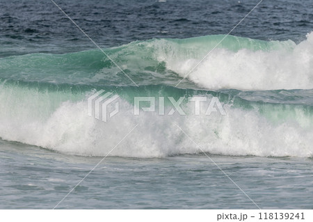 Wave of the green and blue Atlantic Ocean at the edge of a beach in the Iroise Sea. Wave of the green and blue Atlantic Ocean at the edge of a beach in the Iroise Sea. 118139241