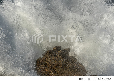 Large waves of the Atlantic Ocean crash against the rocks of a cliff Large waves of the Atlantic Ocean crash against the rocks of a cliff 118139262