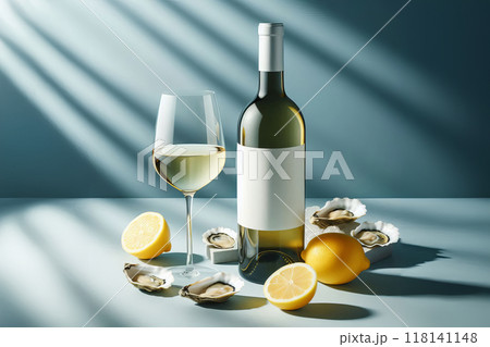 Blank labeled white wine bottle next to full glass, blue lightshadow backdrop, with lemon slices and oysters. Fresh, elegant setting ideal for seafood and wine pairing concept 118141148