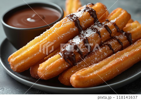 Indulge in warm, crispy churros drizzled with rich chocolate sauce for a delightful dessert experience at any time of day 118141637