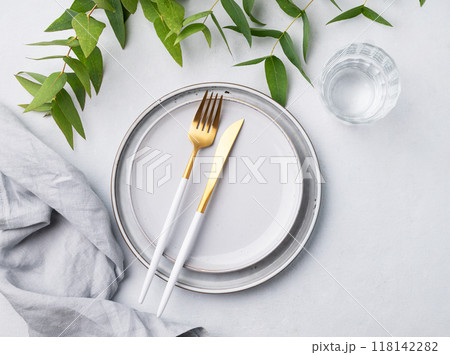 Festive table setting with plates and glass for a spring celebration, wedding, birthday  118142282