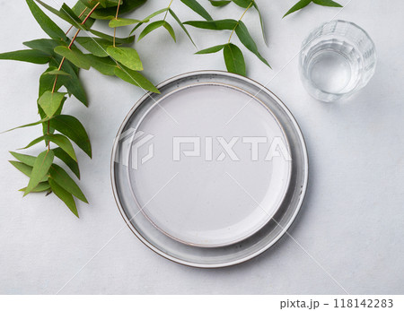 Festive table setting with plates and glass for a spring celebration, wedding, birthday  118142283