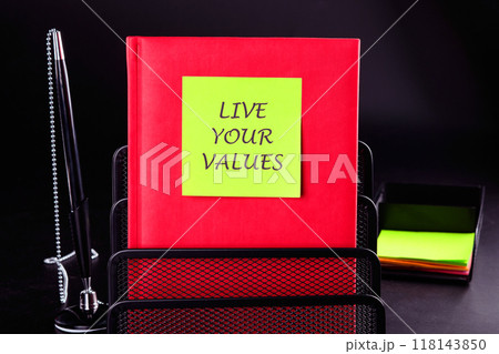 Business, psychological and live your values concept. Copy space. LIVE YOUR VALUES words written on a red book in front of a black background 118143850