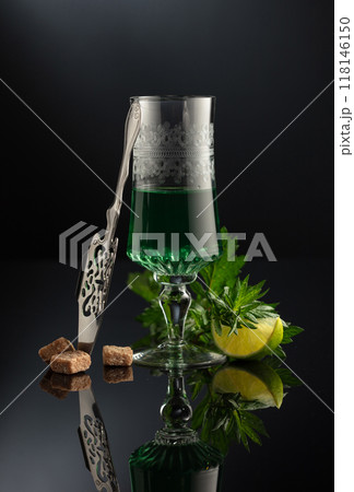 Glass of absinthe with ingredients on a black background. Glass of absinthe with ingredients on a black background. 118146150
