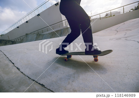 Skateboarder skateboarding at skatepark in city Skateboarder skateboarding at skatepark in city 118146989