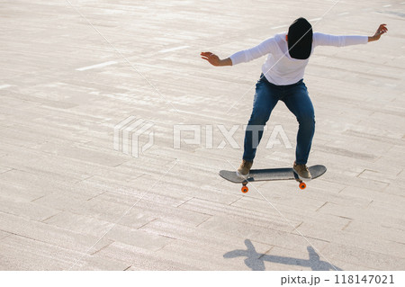 Skateboarder skateboarding outdoors in city Skateboarder skateboarding outdoors in city 118147021