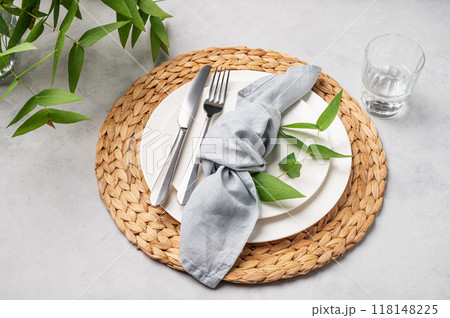 Festive table setting with white plates and glass for a spring celebration, wedding, birthday  118148225