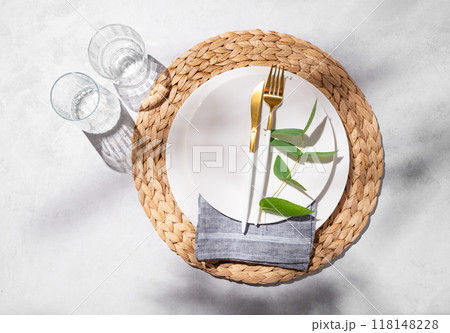 Festive table setting with white plates and glasses for a spring celebration, wedding, birthday  118148228