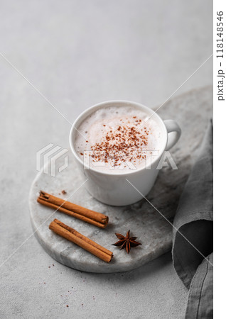 White mug of hot cocoa or chocolate with whipped cream, cinnamon sticks and star anise 118148546