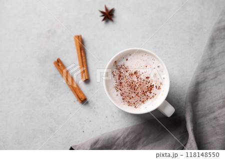 White mug of hot cocoa or chocolate with whipped cream, cinnamon sticks and star anise  118148550