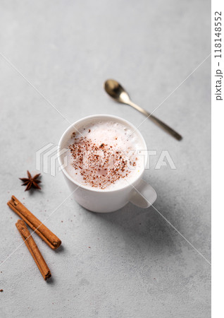 White mug of hot cocoa or chocolate with whipped cream, cinnamon sticks and star anise 118148552
