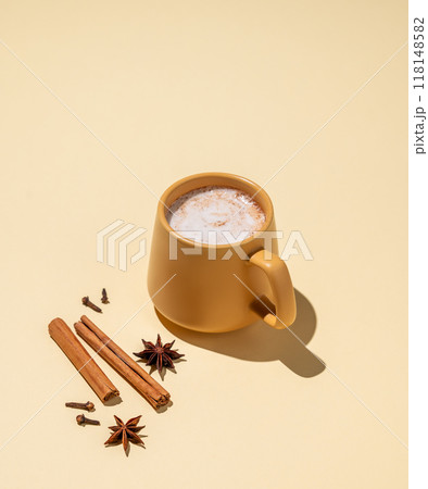 Masala latte tea. Traditional Indian drink with a mixture of spices and herbs. Masala latte tea. Traditional Indian drink with a mixture of spices and herbs. 118148582