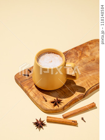 Masala latte tea. Traditional Indian drink with a mixture of spices and herbs. Masala latte tea. Traditional Indian drink with a mixture of spices and herbs. 118148584