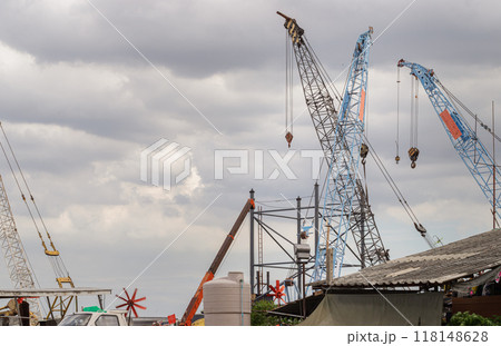 Latticed boom crawler crane of heavy-duty used for rebuilding bridges near the river in Thailand. Latticed boom crawler crane of heavy-duty used for rebuilding bridges near the river in Thailand. 118148628
