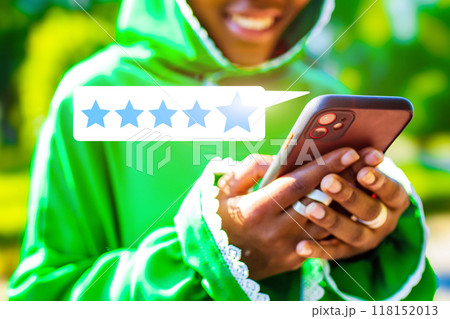 A person is holding a cell phone with a star rating on it A person is holding a cell phone with a star rating on it 118152013