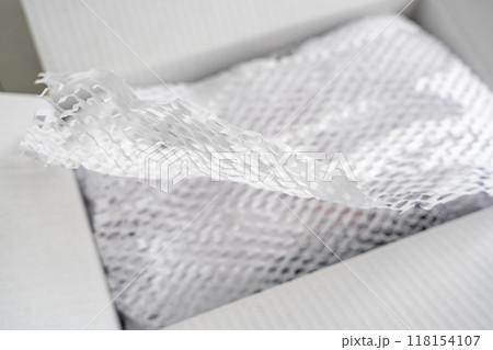 Corrugated white paper for safe transportation, in which the goods brought by the courier delivery service are wrapped, environmental packaging concept Corrugated white paper for safe transportation, in which the goods brought by the courier delivery service are wrapped, environmental packaging concept 118154107