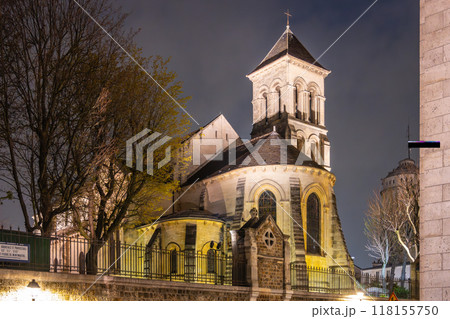 The Church of Saint-Pierre de Montmartre is illuminated under the night sky, showcasing its architectural beauty in Paris, France. The Church of Saint-Pierre de Montmartre is illuminated under the night sky, showcasing its architectural beauty in Paris, France. 118155750