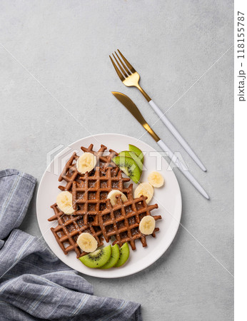 A freshly prepared chocolate waffles with kiwi, blueberries and banana slices A freshly prepared chocolate waffles with kiwi, blueberries and banana slices 118155787