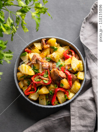 Fried pork meat with potatoes, onions and peppers. National homemade Georgian dish ojakhuri Fried pork meat with potatoes, onions and peppers. National homemade Georgian dish ojakhuri 118155896