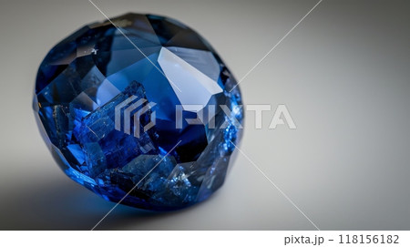CloseUp Photograph of a Single Polished Sapphire on Light Background, Perfect for Jewelry and Gemstone Enthusiasts 118156182