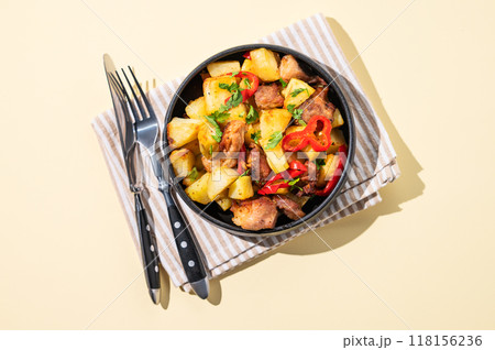 Fried pork meat with potatoes, onions and peppers. National homemade Georgian dish ojakhuri  118156236