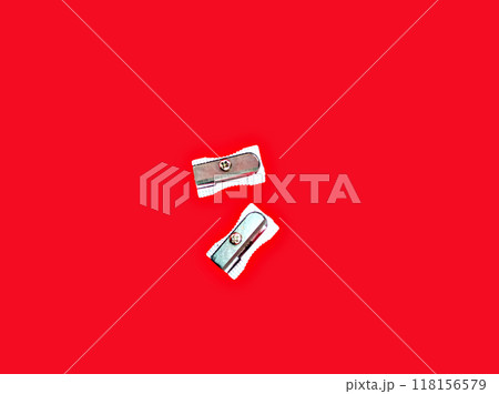Pencil sharpener isolated on red background. Office supplies. Back to school Pencil sharpener isolated on red background. Office supplies. Back to school 118156579