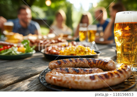 Outdoor gathering with grilled sausages and cold beer 118156653