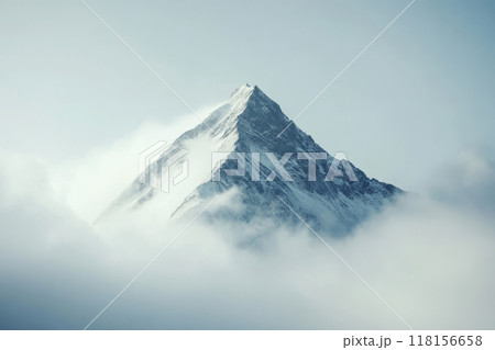 Snow covered mountain peak rises above clouds 118156658