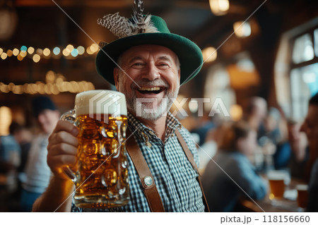 Man smiling and holding a beer stein at Oktoberfest celebration 118156660