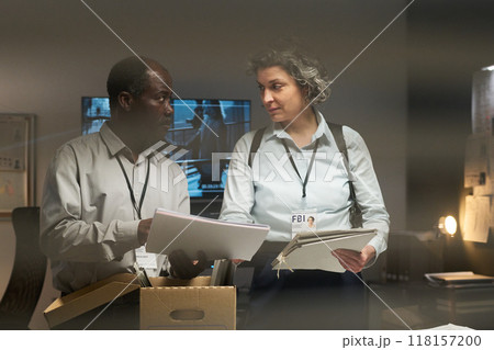 Collaborating FBI Agents Reviewing Documents 118157200