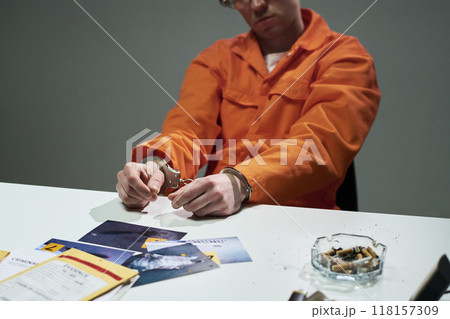 Wearing Orange Jumpsuit Holding Handcuffs Wearing Orange Jumpsuit Holding Handcuffs 118157309