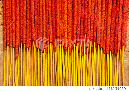 Orange incense sticks are neatly arranged on paper background. Relaxation and spirituality concepts. Orange incense sticks are neatly arranged on paper background. Relaxation and spirituality concepts. 118159059