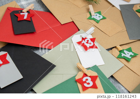Traditional twenty four days advent calendar before Christmas holidays. Numbers on envelopes Plastic free zero waste sustainable decoration. Winter cozy home Catholic traditions of Christmas countdown 118161243