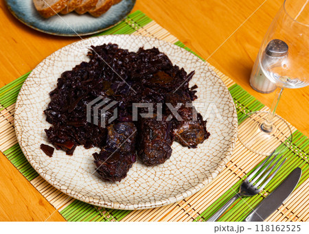 On plate there is stewed cabbage with delicious pork ribs 118162525