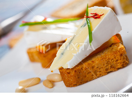 Toasted bread with soft blue cheese and orange Toasted bread with soft blue cheese and orange 118162664