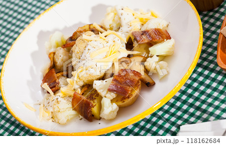 Cauliflower with potatoes and brisket meat served with cheese sauce 118162684