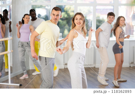 Young man and woman practicing active dance in pair in training hall 118162893